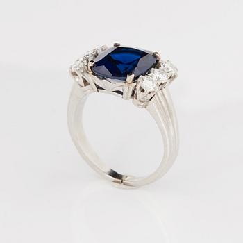 A RING set with a faceted sapphire.