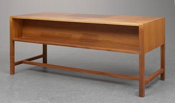 A Josef Frank walnut desk by Svensk Tenn, the front with five drawers, the backwith a bookshelf.