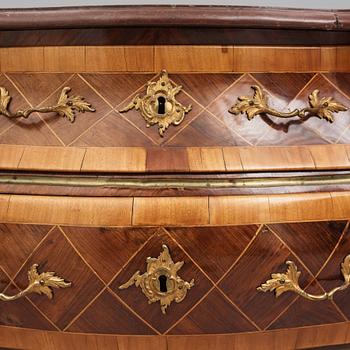 A Swedish rosewood-veneered Rococo chest of drawers, later part of the 18th century.