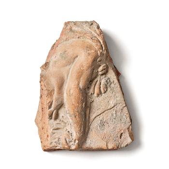 211. A presumably Hellenistic terracotta fragment, decorated in relief with an arm.
