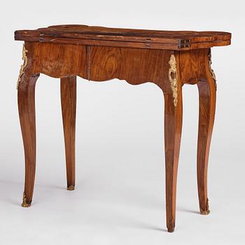 A Swedish walnut-veneered and gilt-brass mounted rococo games table, later part of the 18th century.