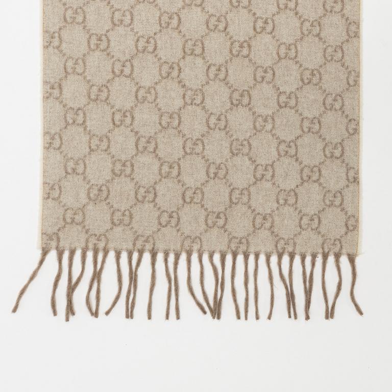 Gucci, a monogram cashmere scarf.