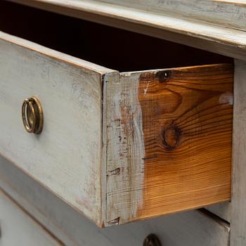 a chest of drawers from the first half of the 19th century.