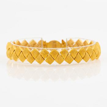 Garnityr av guldsmycken, en collier (14K), ett armband (18K), ett par örhängen (14K) och en ring (14K).