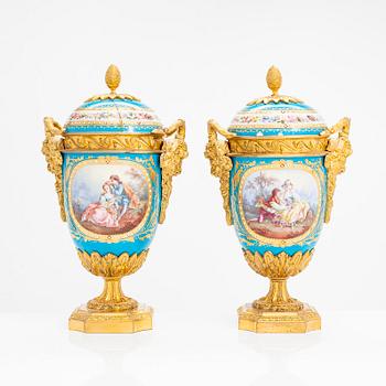 A pair of French porcelain urns from around the turn of the 20th century.