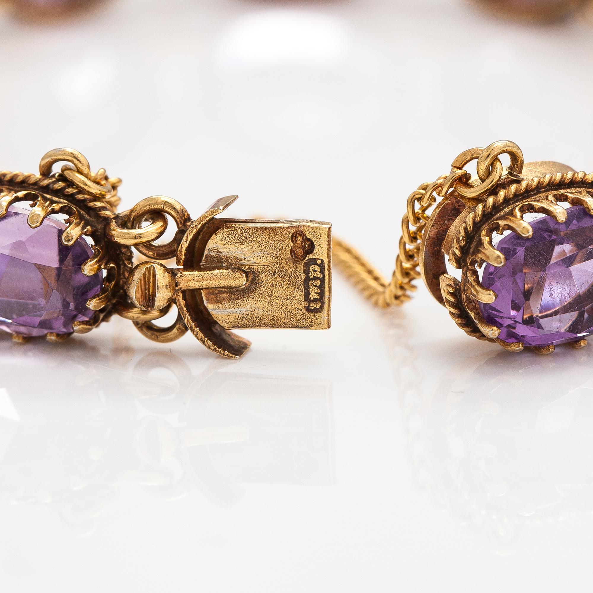 A necklace, bracelet and two brooches in gilded silver and with amethysts and pearls.