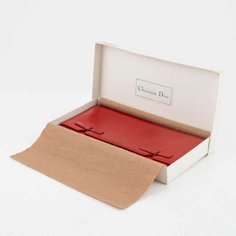 Christian Dior, a red box calf leather clutch.