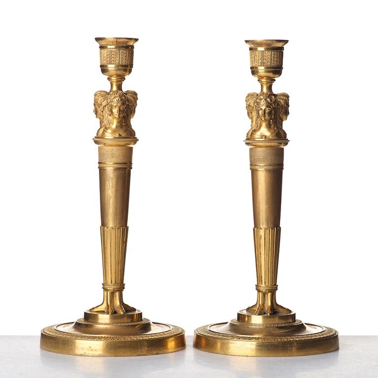 A pair of French Empire early 19th century gilt bronze candlesticks.