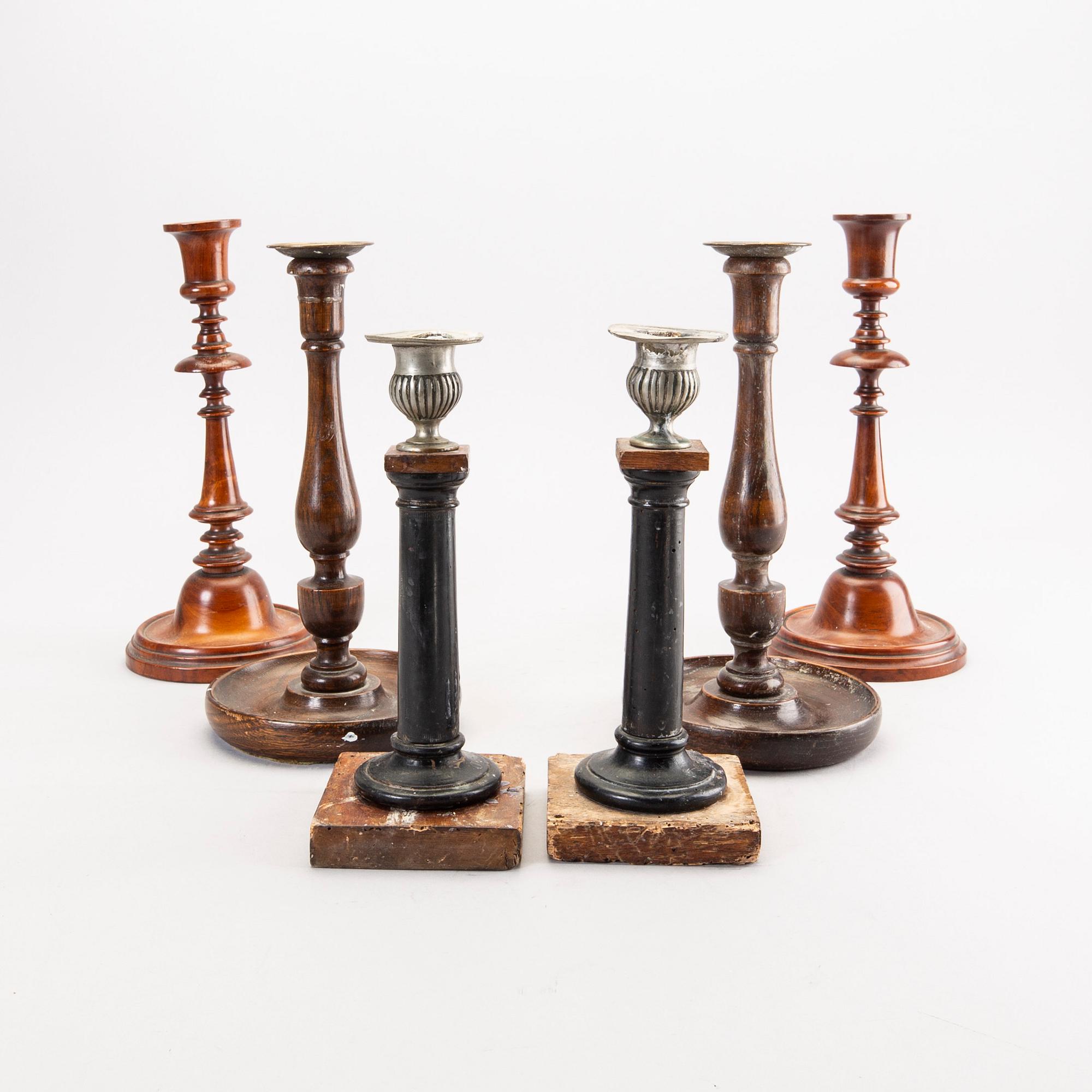A set of three wooden pairs of candle sticks around 1900.