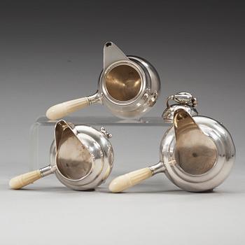 A Georg Jensen sterling 'Blossom' set of a lidded chocolate jug and two creamers, Copenhagen 1925-32 and 1933-44.