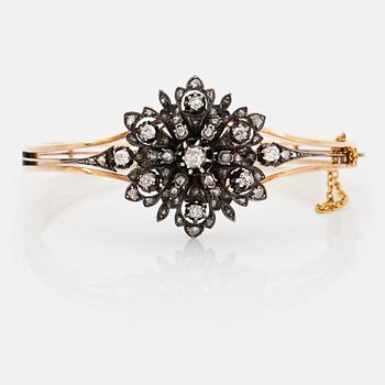 1017. A 14K gold and silver bangle set with old- and rose-cut diamonds.