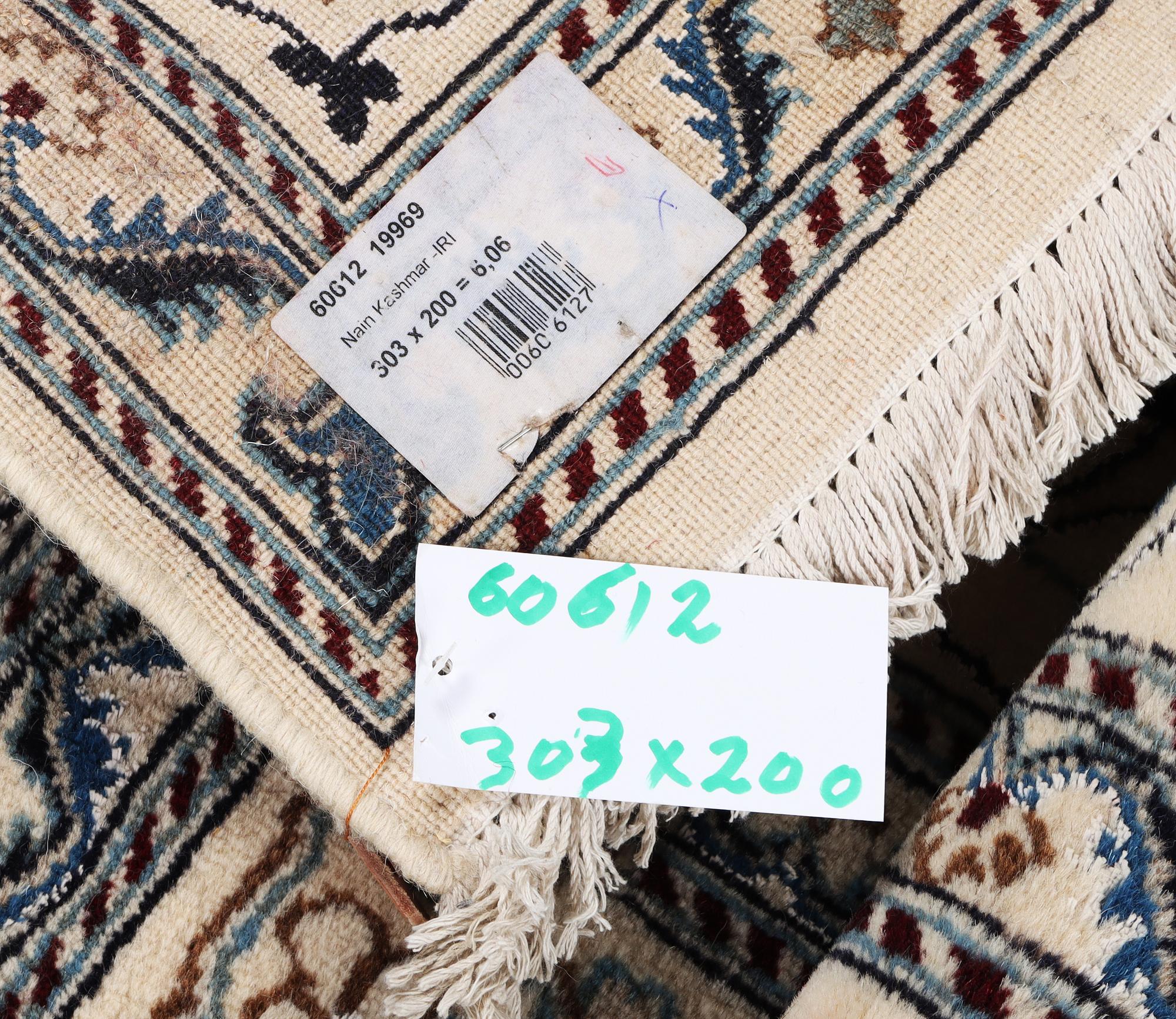 A Nain carpet, part silk, c. 303 x 200 cm.