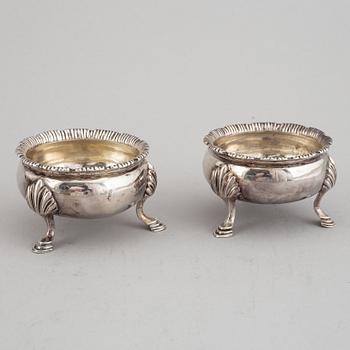 Two pairs of English 18th century silver salt-cellars, marked in London 1762 and 1769.