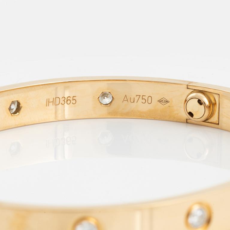 A Cartier "Love" bracelet in 18K gold set with ten round brilliant-cut diamonds.