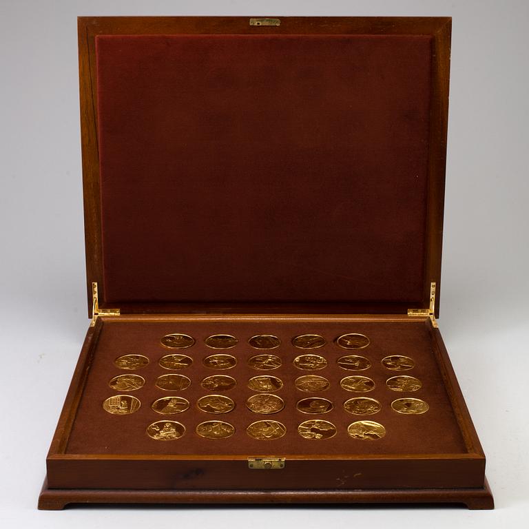 A collection of 31 gold-plated silver coins from Franklin Mint.