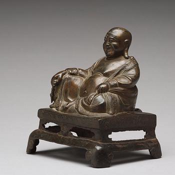 A setated bronze figure of Buddai, Qing dynasty (1664-1912).