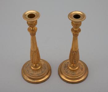 A PAIR OF EMPIRE CANDLESTICKS.