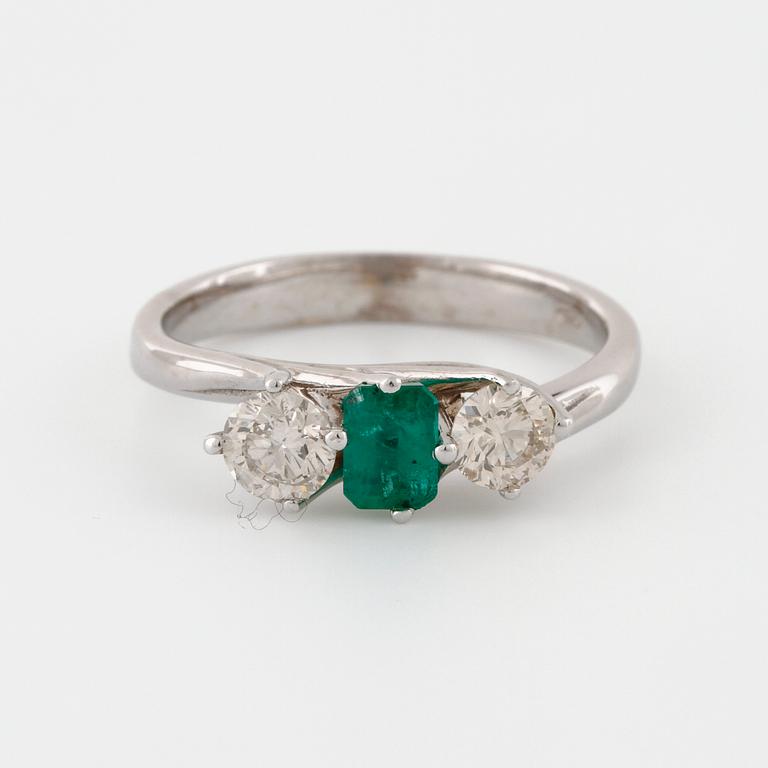 A emerald and brilliant cut diamond ring.