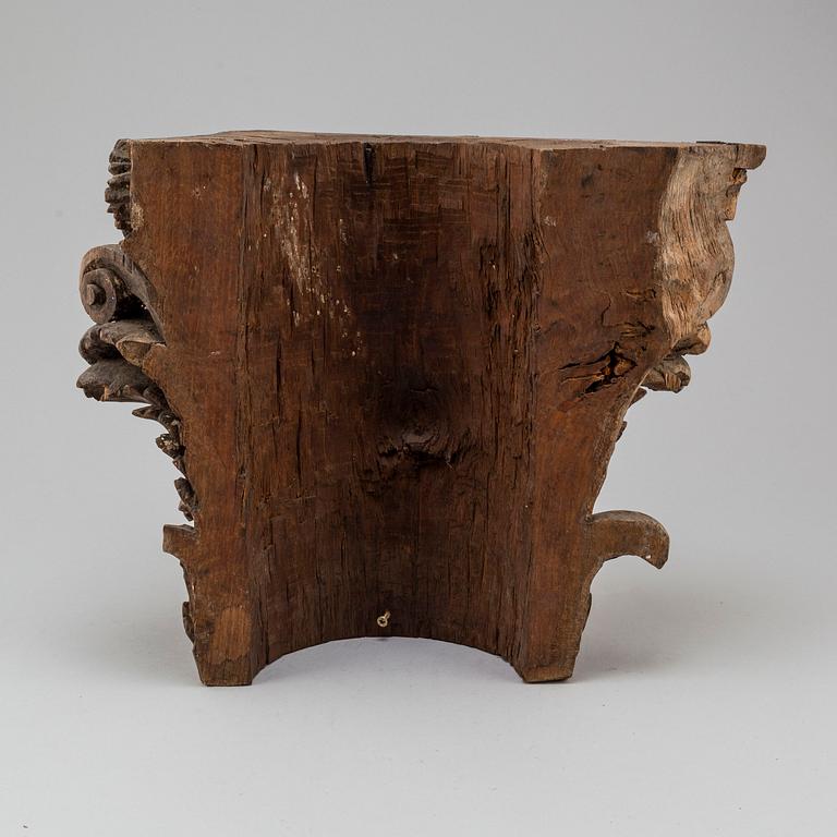 An 18th century carved wood corinthian capital.