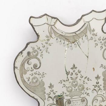 A North European rococo one-branch engraved glass girandole mirror, mid 18th century.