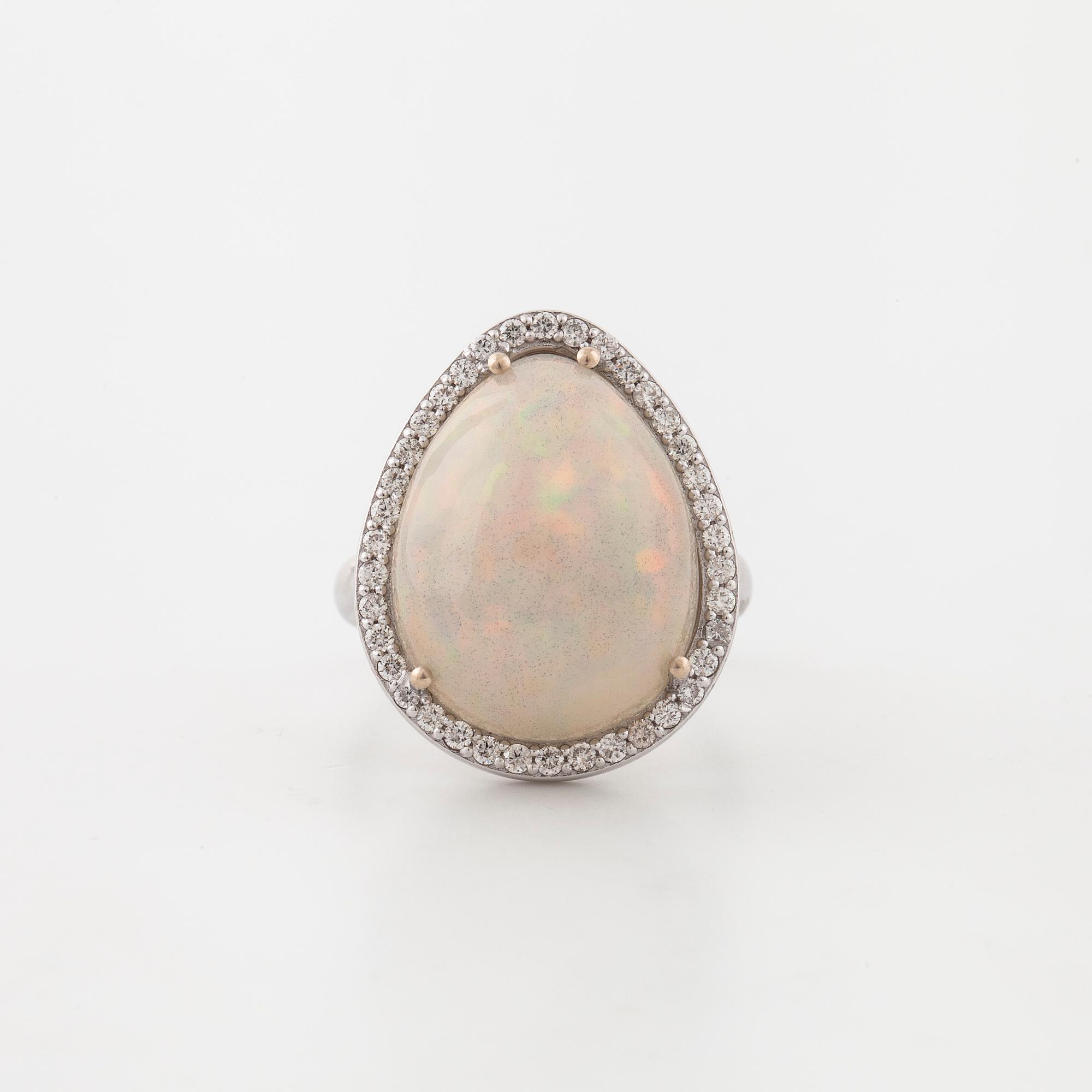 A cabochon cut white opal and a brilliant cut diamond ring.