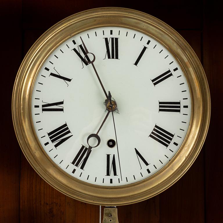A walnut long case clock, from around the year 1900.