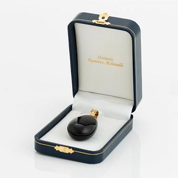 An 18K gold and onyx Acchinelli pendant set with round brilliant-cut diamonds.