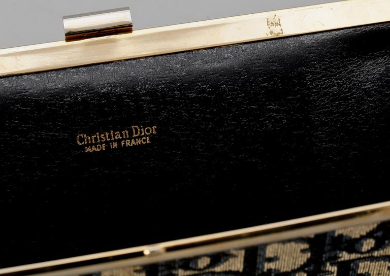 A blue monogram canvas clutch by Christian Dior.