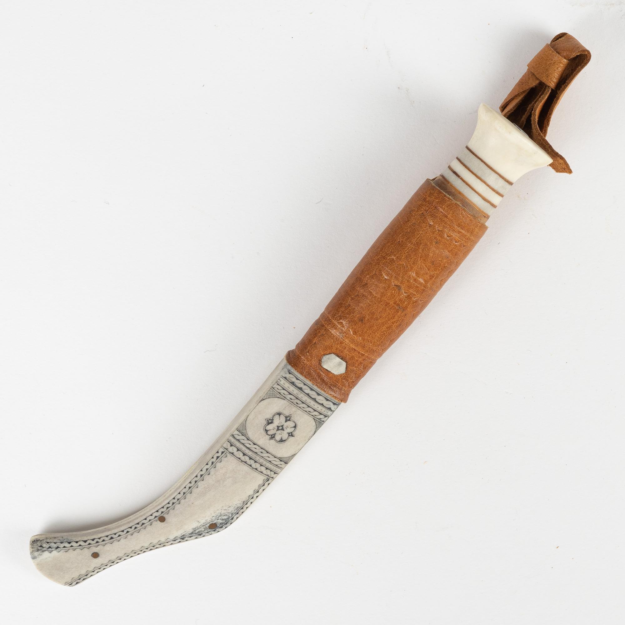 A reindeer horn knife by Johan Tuuri, signed.