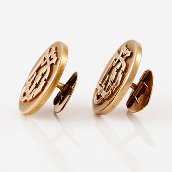A pair of cufflinks 14K gold with monogram.