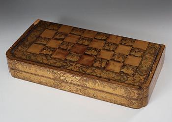 A black lacquer chess game with 32 + 38 ivory and bone figures, late Qing dynasty (1644-1912).