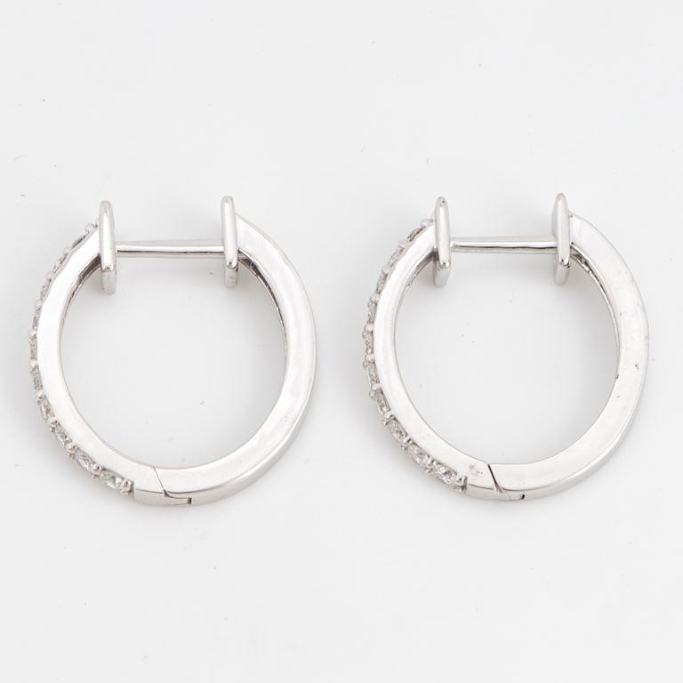 Brilliant-cut diamond hoop earrings.