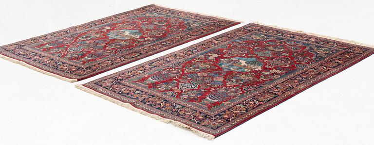 A pair of semi-antique pictoral Kashan rugs, ca 200 x 130 and 197 x 128 cm.