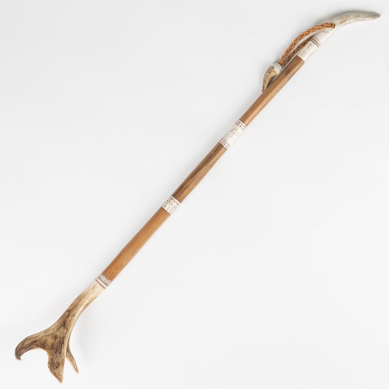 A reindeer horn back scratcher, unidentified signature.