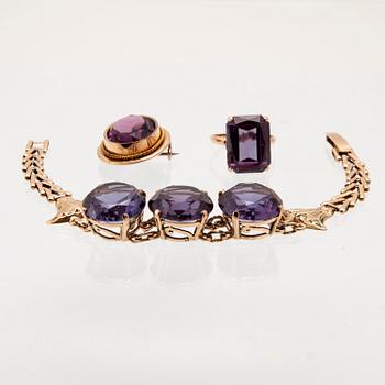 Bracelet, ring, and brooch in gold with synthetic colour-changing sapphires and glass.