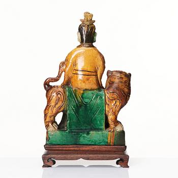 A green and yellow glazed figure of a dignitary and a tiger, Ming dynasty (1368-1644).