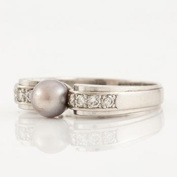 A W.A. Bolin ring in platinum with a pearl and round brilliant-cut diamonds.