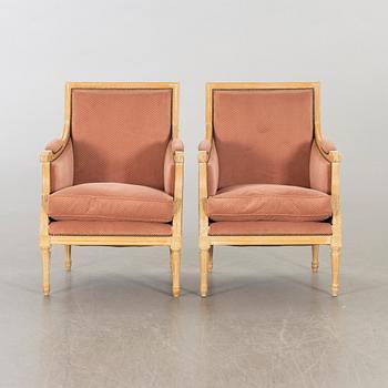 A pair of 20th century gustavian style armchairs.
