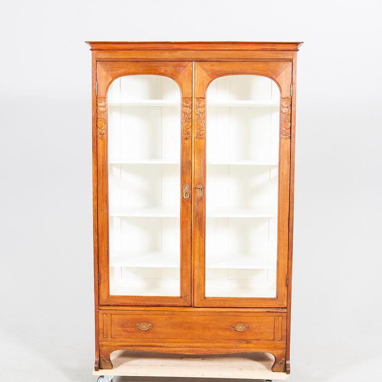 An early 1900s oak display cabinet.