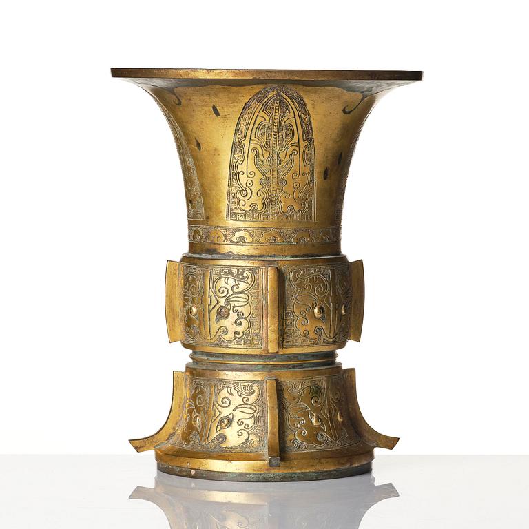A parcel gilt/gold splashed bronze vase, Gu, 17/18th century.