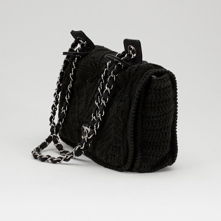 CHANEL, a black crochet flap evening shoulder bag.