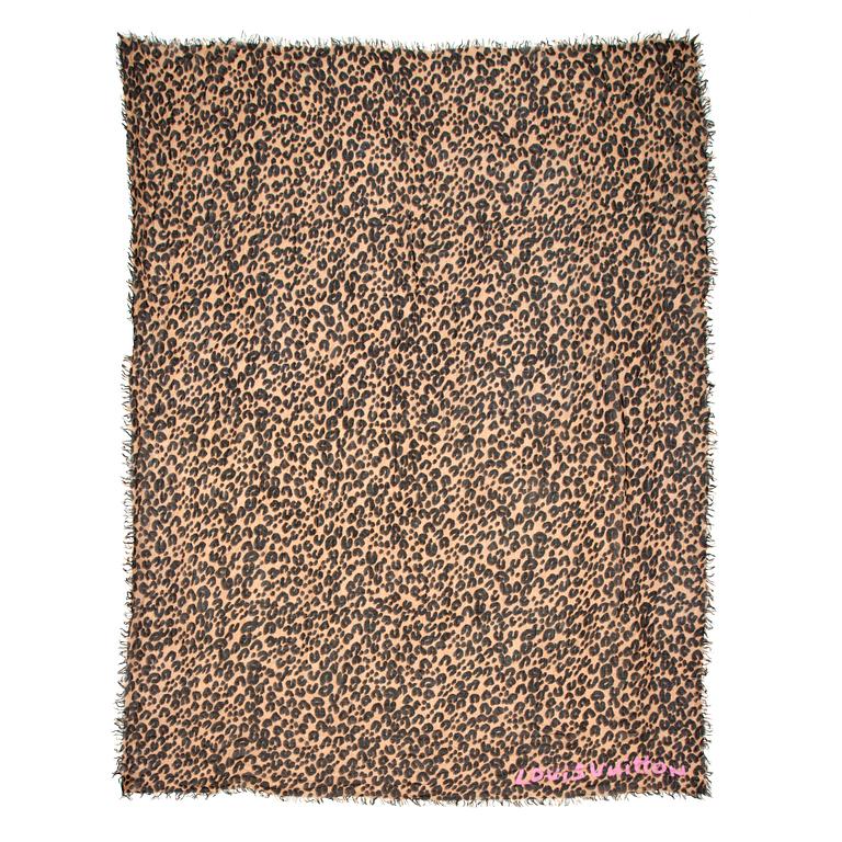 LOUIS VUITTON, a leopard patterned shawl.