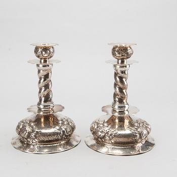 A pair of silver baroquestyle candlesticks. W.H.H, Stockholm. 1935. Filled foot.