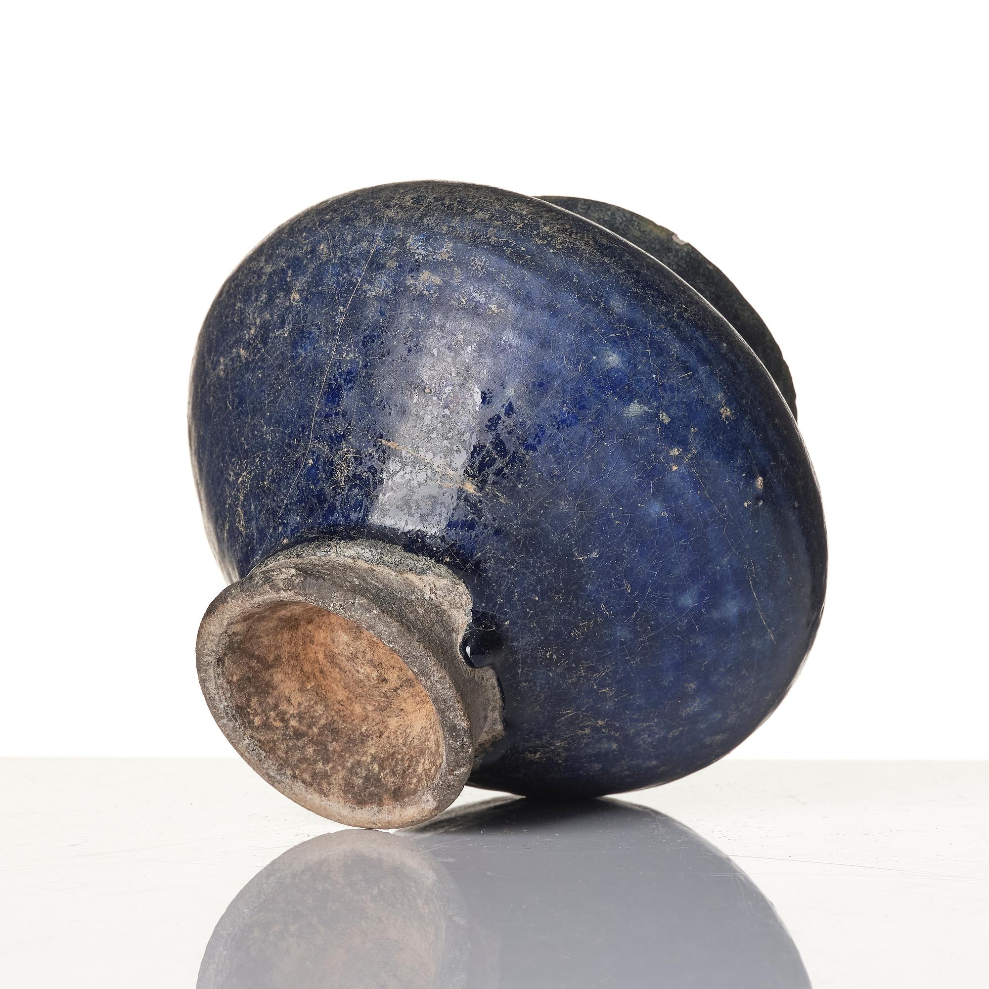 A blue-glazed Nishapur pottery Jug, Persia, 13th century.