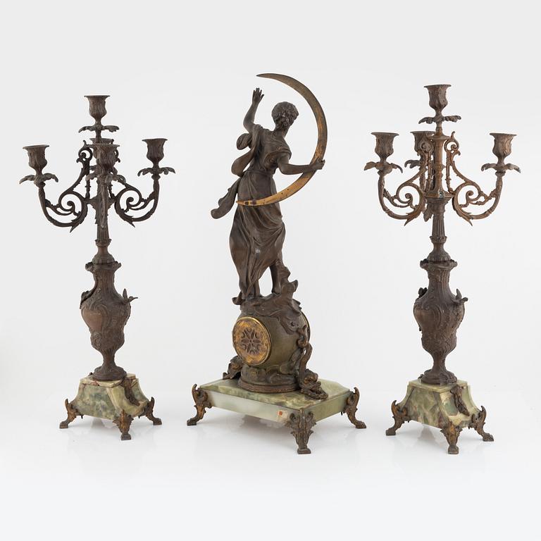 A mantel clock and pair of matching candelabra from the last quarter of the 19th century.