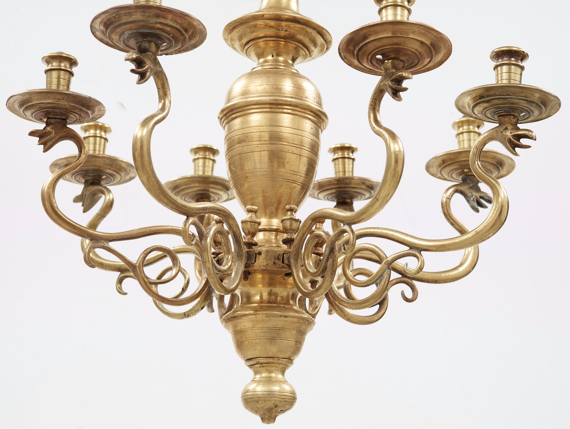 A 19th century eight-light brass chandelier in the manner of Hans Rogiers van Harelbeke.