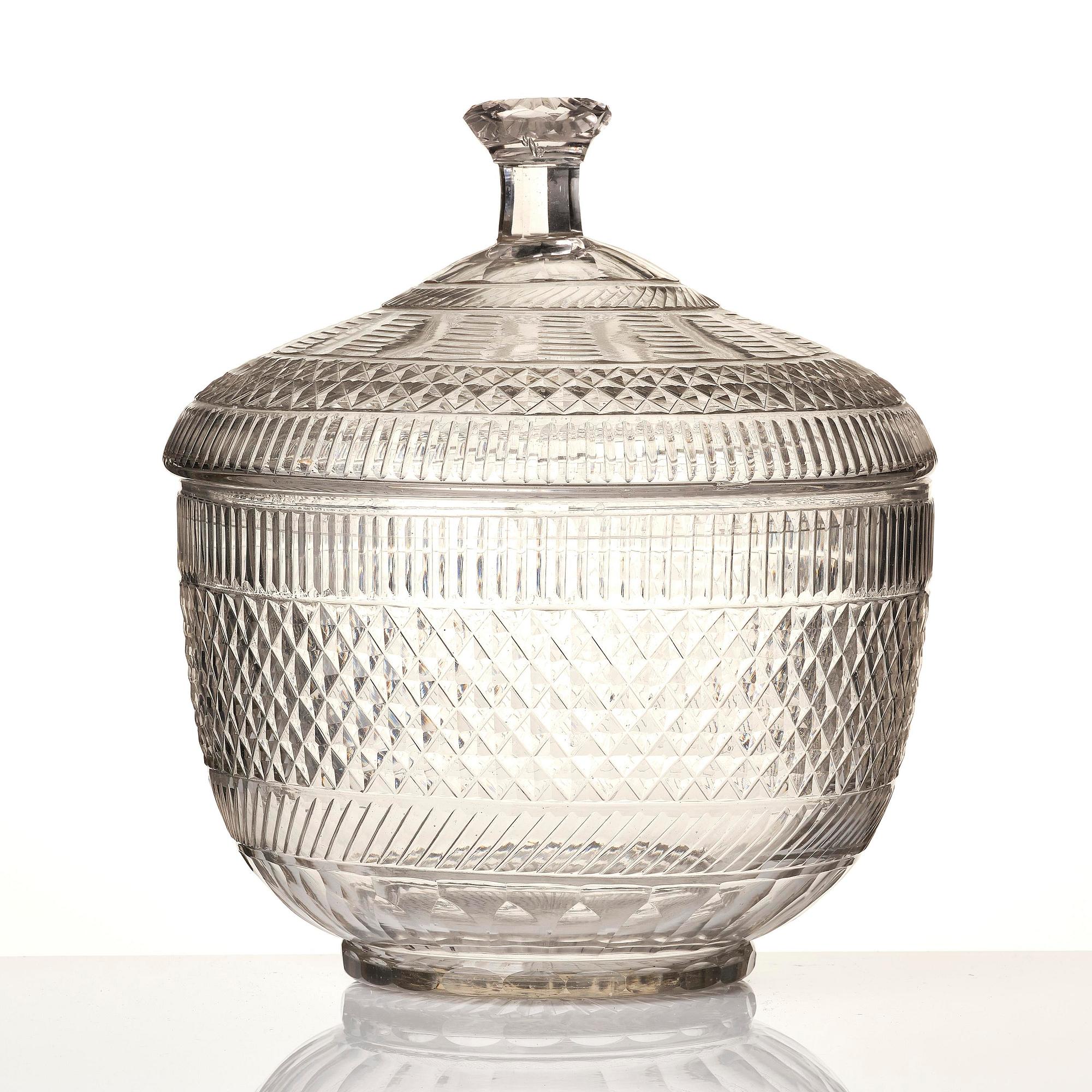 A cut glass punch bowl with cover, stand and ladle, Empire, first part of the 19th century.