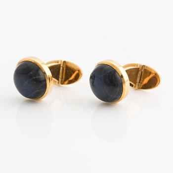 CF Carlman a pair of 18K gold cufflinks with a blue stone, likely spectrolite.