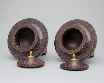 A pair of late Gustavian early 19th century porphyry urns with cover.