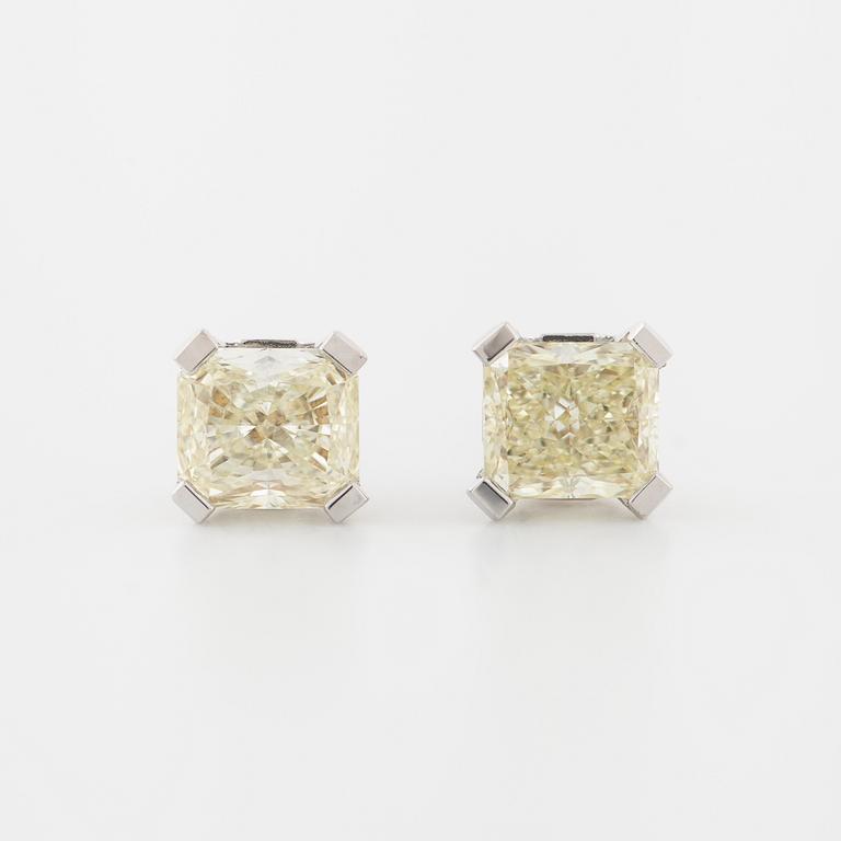 A pair of radiant cut diamond earrings.